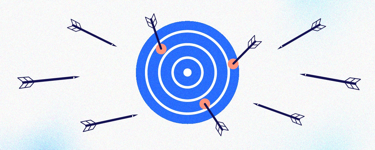 A blue bull's eye target with several darts missing the bull's eye