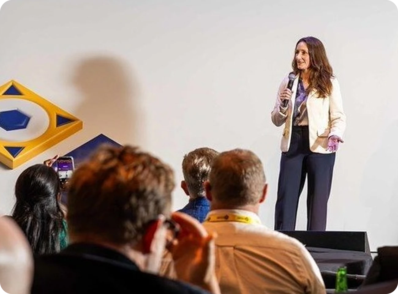 Siteimprove.ai CMO Jen Jones on stage to an audience at a technology conference, highlighting Siteimprove.ai’s focus on digital accessibility and AI search visibility for TechShare Pro 2026.