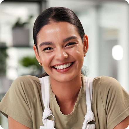 Professional smiling while working in a modern office environment.